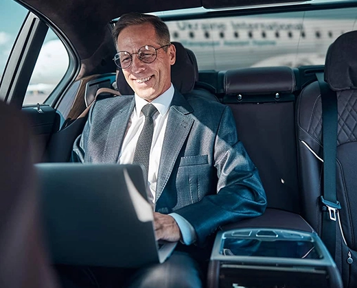 Business executive enjoying airport transfer | Top Class Chauffeurs, luxury limo, airport transportation, Mercer County, Bergen County