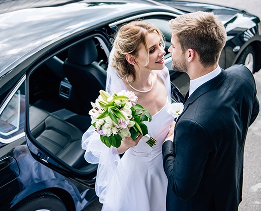 Bride and groom with luxury wedding car | Top Class Chauffeurs, wedding transportation, elegant limo service